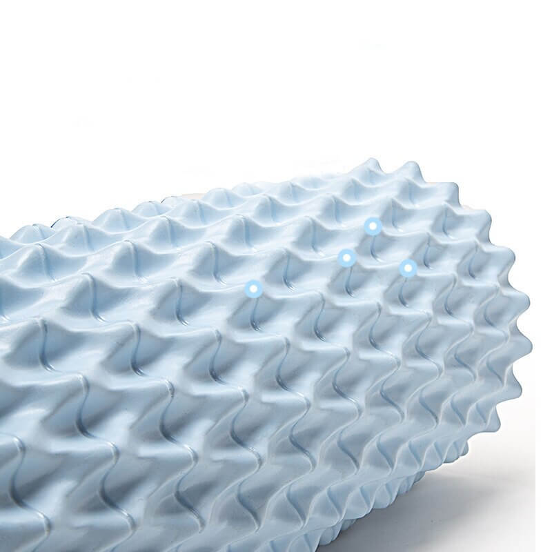 Close-up of ocean blue fishbone yoga pillar foam massage roller, featuring textured surface for deep tissue massage.